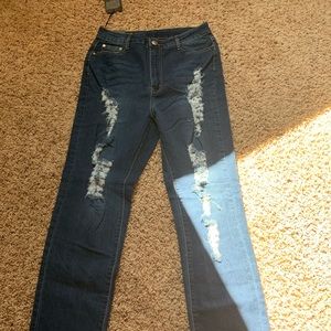 Distressed dark blue jeans